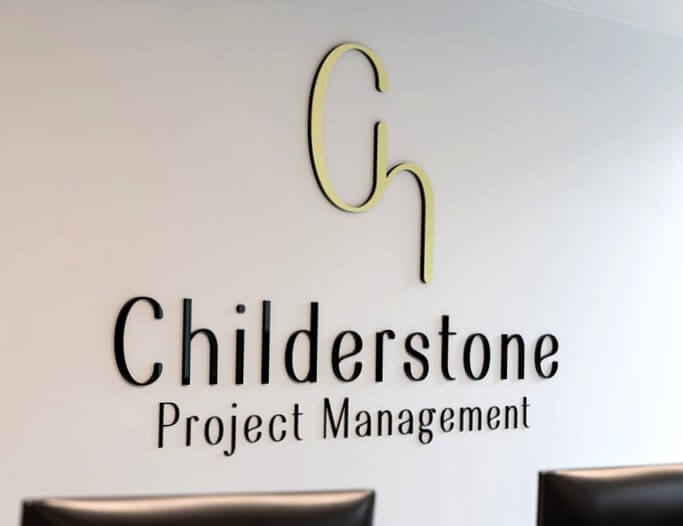 The interior wall-mounted "Childerstone Project Management" signage and logo.